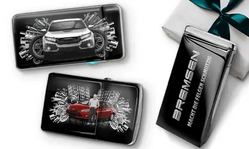 Drei elegante schwarze Geldbörsen mit Bildern von Autos und Zahnrädern, platziert neben einer Geschenkbox. Auf einer steht „Bremsen“. Das Design ist dynamisch und modern.
