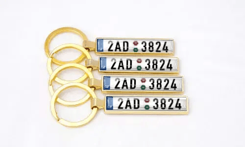 Gold metal license plate keychains highlight personalized car accessories