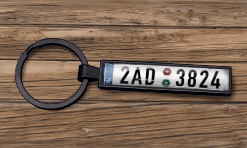 Custom license plate keychain appears with a matte black finish