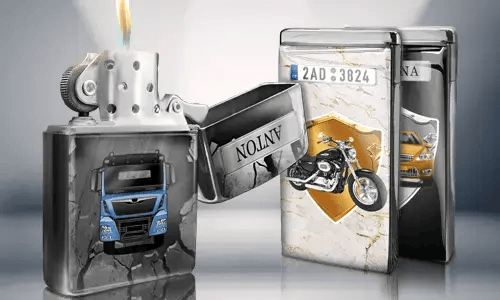Open metal lighter with a blue truck design, flame lit. Behind are two closed lighters with images: a motorcycle and a car with license plates.