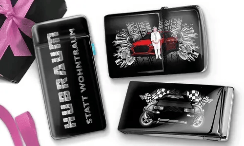 Three black and silver car-themed cigarette cases with dynamic graphics. One reads 