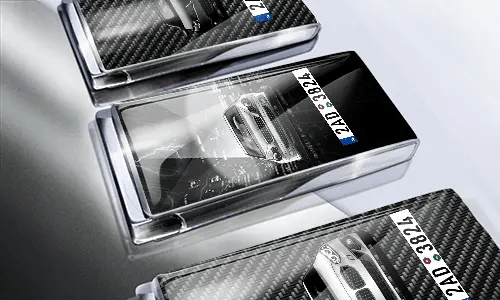 Three car-themed boxes with glossy finish: silver with car, black with cityscape and black car, red with car front