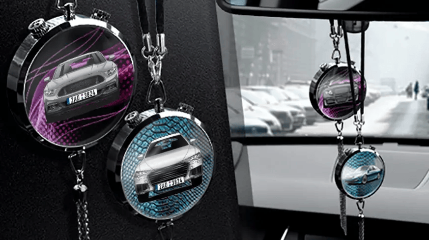 Two circular car air fresheners hanging from rearview mirror: left with black car, right with blue car